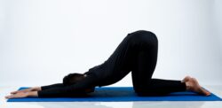 Woman doing puppy pose on a yoga mat