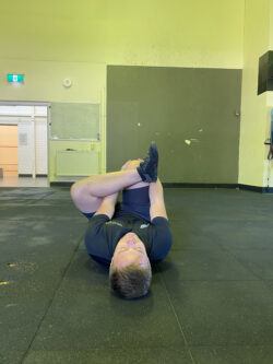 justin performing a figure 4 stretch