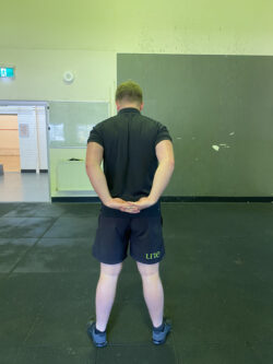 Justin performing a rear arm stretch